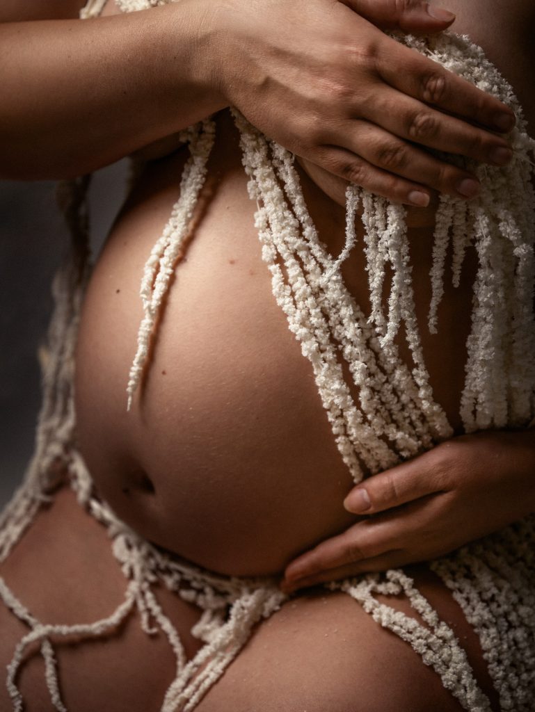 belly close up painterly portrait nude wrapped in white flowers Sutton Surrey photographer