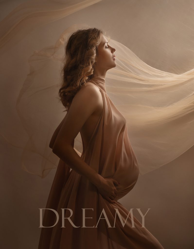 Dreamy Soft painterly pregnancy studio portrait pregnant lady standing on the side holding belly in a feminine way gentle light Sutton Surrey London maternity photoshoot