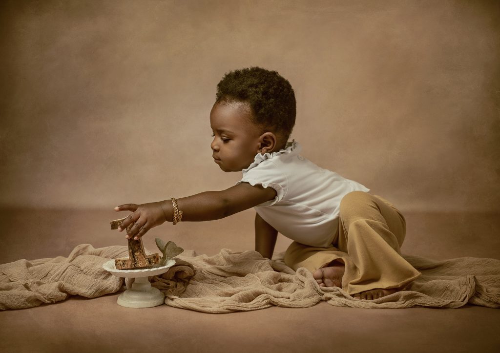 Baby First Birthday Studio photoshoot baby reaching wooden number one vintage mood South London photography