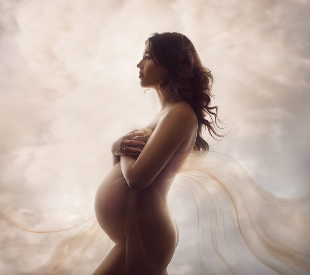 backlit dreamy studio maternity portrait showing pregnancy forms in a soft light body shape photo in Surrey studio