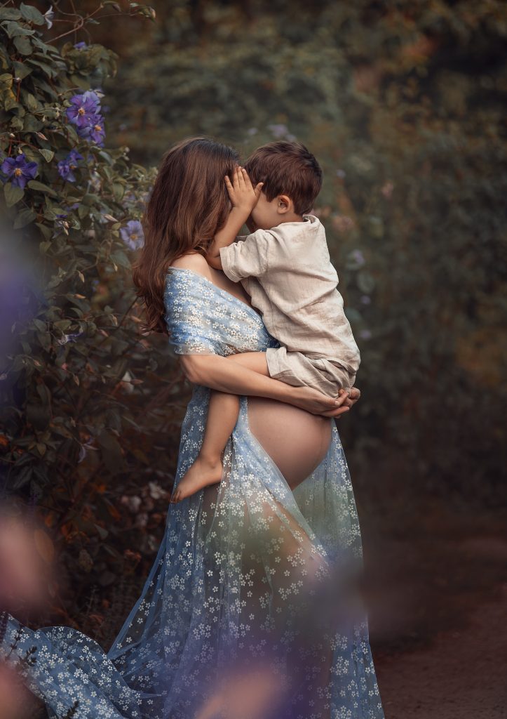 Family maternity photography session with expectant mother and older child in Surrey
