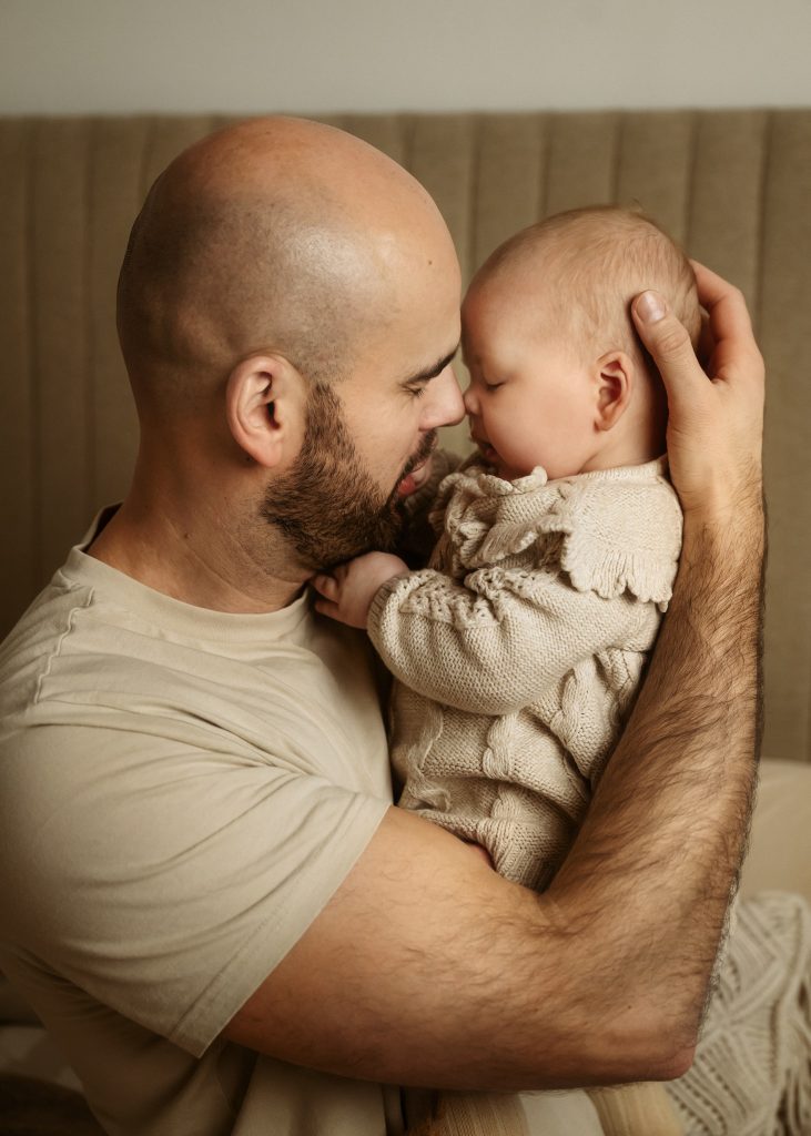 dad and baby connection emotional moment captured at family home natural family photoshoot in Sutton Surrey