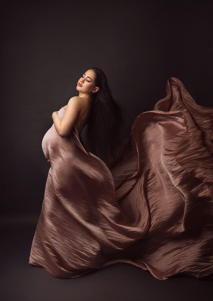 elegant studio in Sutton pregnancy wearing flowing fabric emotional mood Surrey