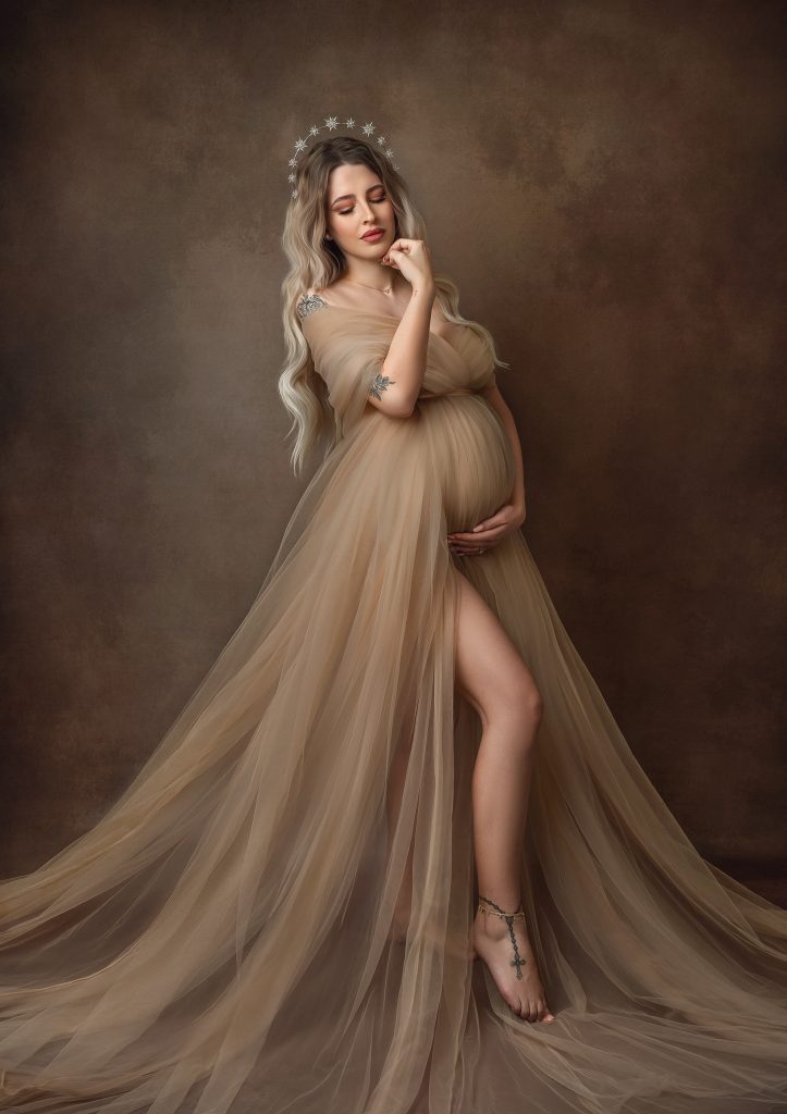 dreamy maternity studio portrait pregnant lady wrapped in creamy tulle dress emotive mood painterly style photography in Sutton Surrey and London