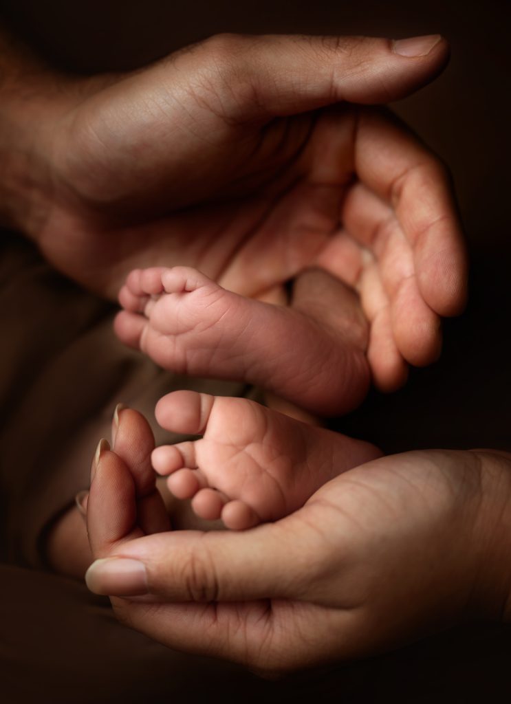 baby feet detail shoot parents hands holding tiny feet baby and family photography in Sutton Carshalton Wallington Croydon Purley Cheam Surrey