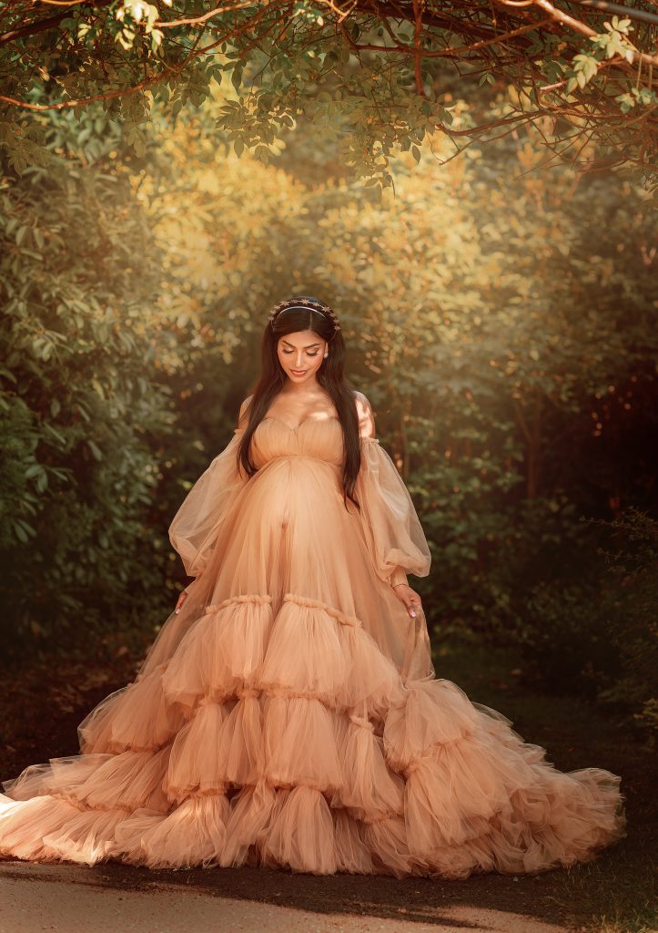 Cheam Nonsuch park pregnancy photography lady wearing beige long tulle dress dreamy mood South London photoshoot