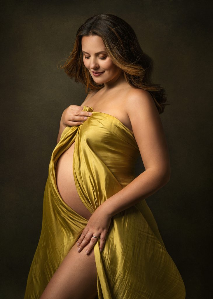 Elegant maternity studio close up pose lady looking down belly holding satin fabric classic Sutton South London photography