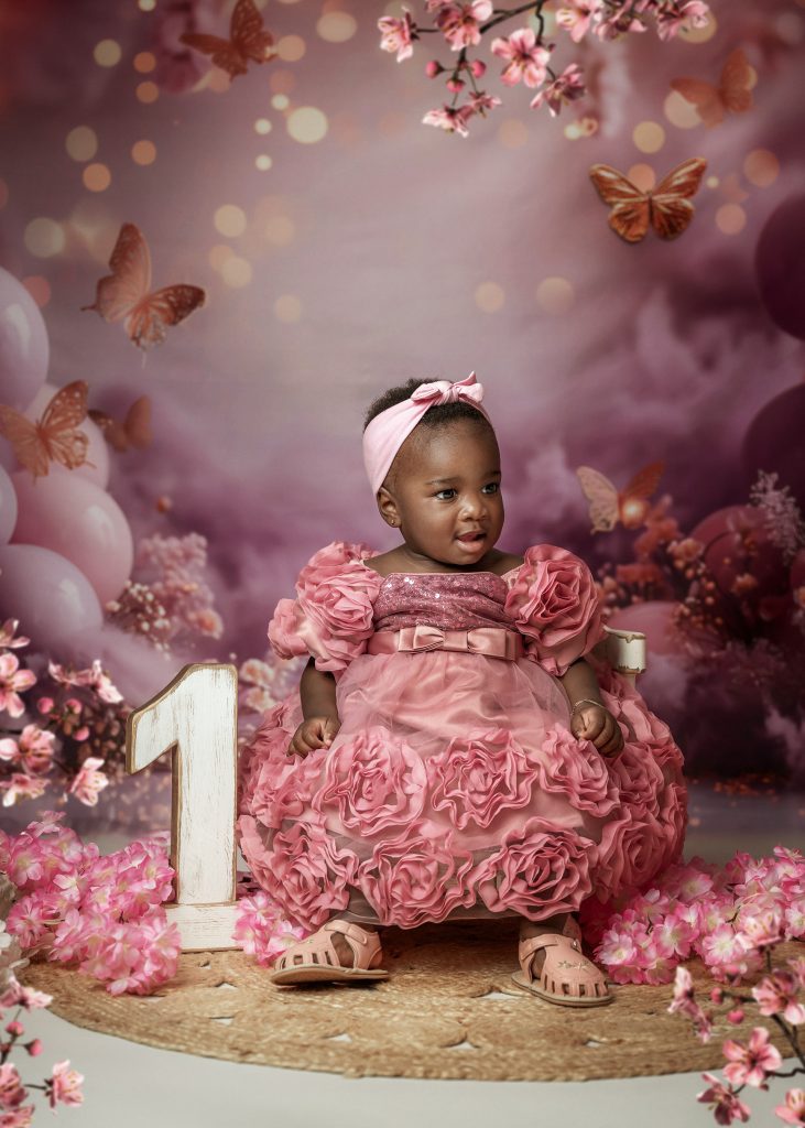 Baby first birthday studio portrait pink dress butterflies and girly mood Surrey South London photoshoot