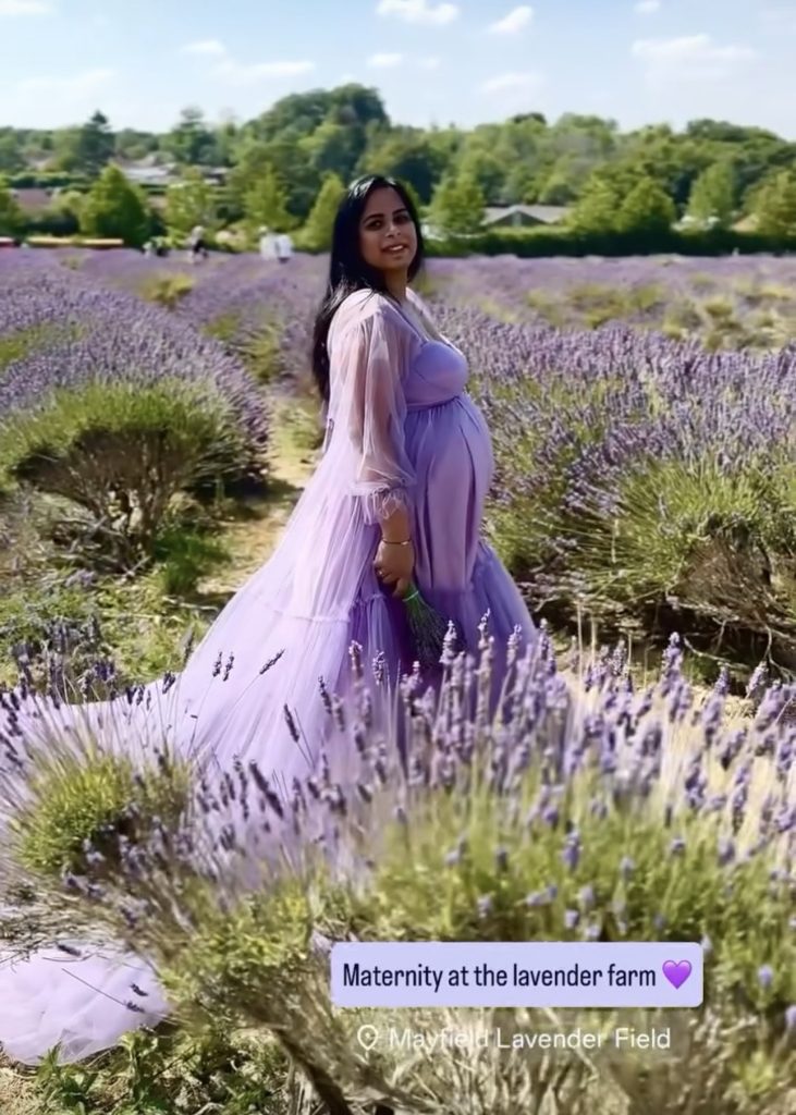 pregnant lady back stage screenshot at Lavender fields in Banstead smiling at the camera wearing long lavender dress