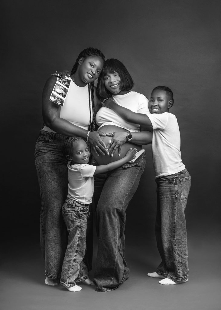 Natural black and white family maternity photos with kids during pregnancy photoshoot in Surrey studio