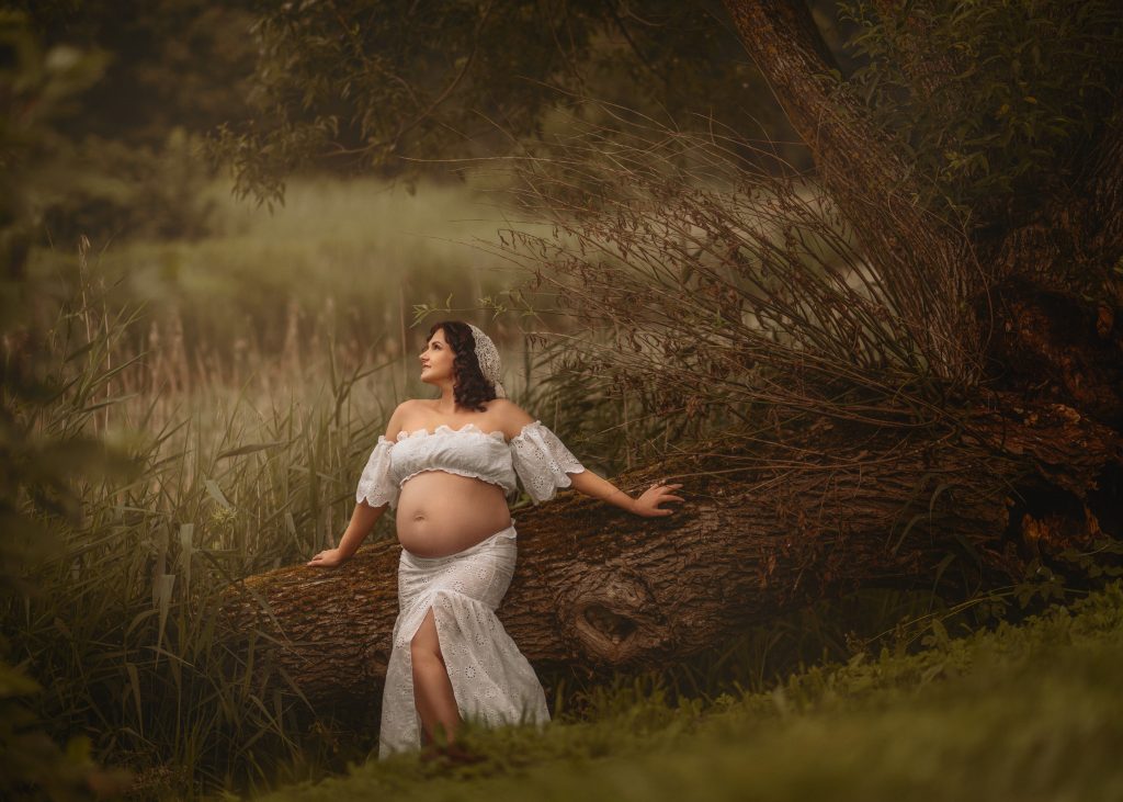 pregnant woman in white beside a fallen tree Surrey photographer
