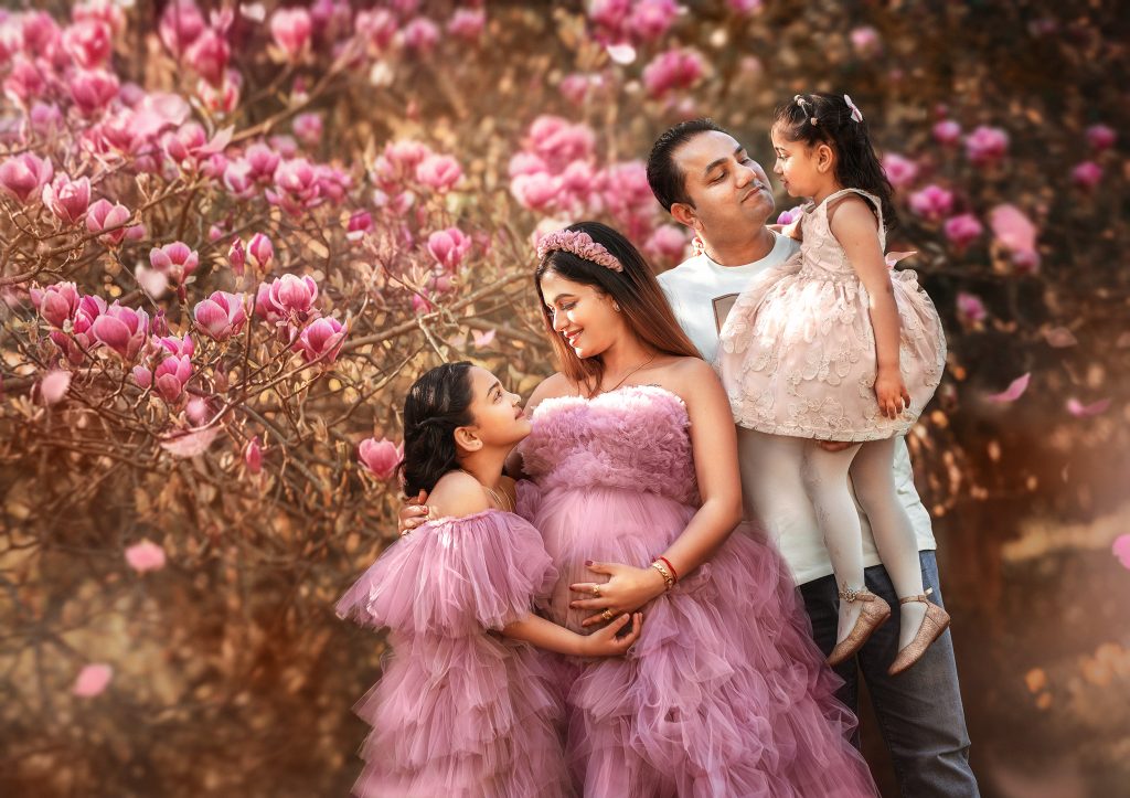 Family maternity photos with expectant parents and child during Surrey park photography session